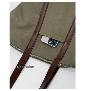 Detail view of khaki canvas tote with side zipper pocket showing phone storage size