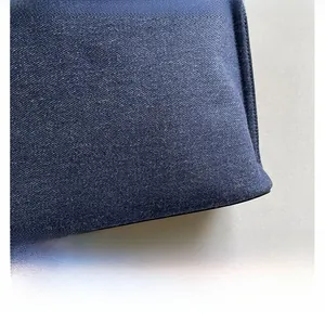 Close-up of premium dark blue denim fabric texture and fine weaving on this tote bag