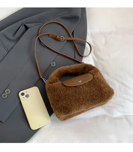 Caramel faux shearling mini tote bag detail showing leather flap and metal snap closure