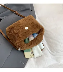 Detailed interior of brown fleece crossbody bag showing spacious storage for phone and cosmetics