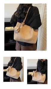 Detail view of khaki PU leather tote bag with matching mini pouch in a lifestyle setting