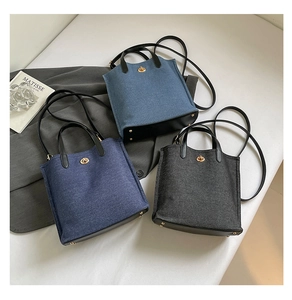 Detailed trio of denim bucket bags in light blue, medium blue, and dark gray tones