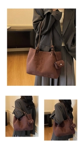 Detail of dark brown faux suede tote bag with matching mini coin purse attachment