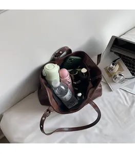 Detailed view of brown leather tote bag interior showing large capacity for daily essentials