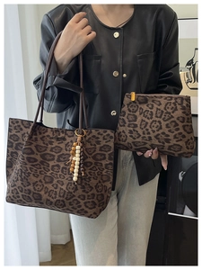 Detail view of leopard print tote bag with matching pouch and bead tassel pendant