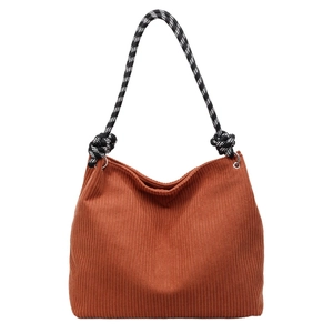 Vintage brown corduroy tote bag with black and white woven shoulder straps and knots