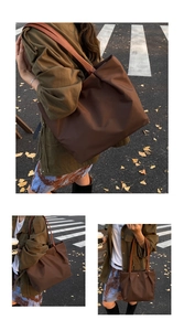 Detail of dark brown waterproof nylon tote bag with leather straps for daily commute