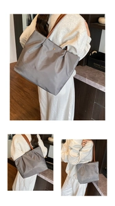 Detail view of large grey nylon tote bag showing spacious interior and magnetic closure