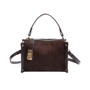 Brown quilted crossbody bag with golden buckle and suede texture in classic square shape