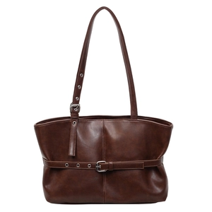 Minimalist deep brown leather tote bag with vintage texture and silver buckle detail
