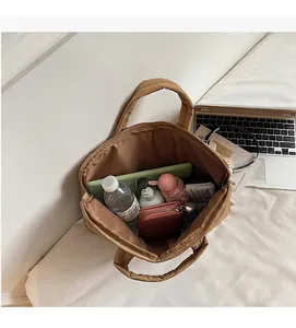Macro shot showing internal large capacity of the quilted tote bag with daily essentials