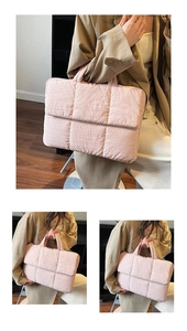 Detail of pink quilted laptop tote bag with soft padded nylon texture and top handles