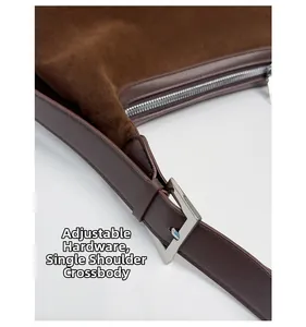 Detail of adjustable silver hardware buckle and premium matte suede strap on retro tote