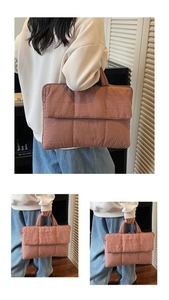 Detail of dusty pink quilted tote laptop bag with puffy texture and zip closure
