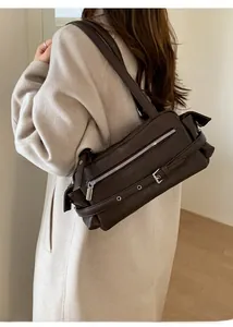 Detail of dark brown leather shoulder bag with silver buckle and vintage belt design