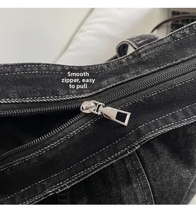 Detail view of high-quality zipper on denim tote bag with contrast stitching