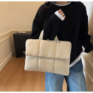 Chic beige quilted puffer tote bag shown in a lifestyle setting for casual winter use