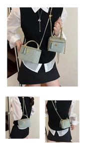 Detail of light green woven box bags with gold flower accents and chain straps