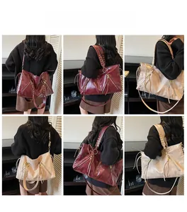 Detail view of large capacity tote bag with woven shoulder straps and tassel zippers