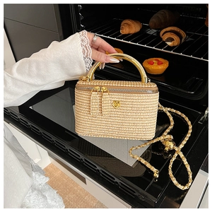 Macro view of woven box bag with gold handles and chain strap in a warm kitchen setting