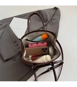Detailed interior of vintage brown suede tote showing spacious storage for cosmetics