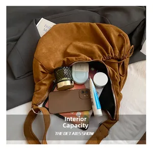 Internal view of brown suede bag showing large storage capacity for daily essentials