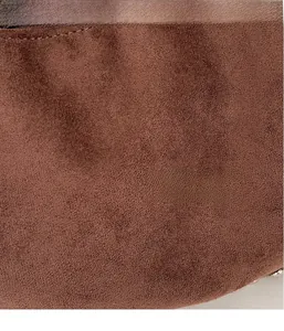 Macro detail of dark brown suede texture with neat stitching and silver metal rivets
