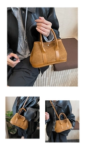 Close-up of caramel suede crossbody bag with metallic rivets and sleek leather trim
