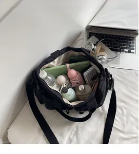 Detailed internal view of spacious black quilted tote bag showing large storage capacity