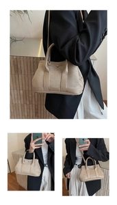 Detail of beige suede tote bag showing mixed textures and round metal buckle detail
