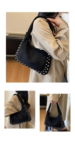 Detail view of black suede hobo bag with silver studs on modern minimalist interior