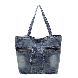 Vintage blue washed denim tote bag with double zipper pockets and casual shoulder straps