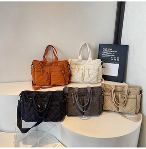 Multiple colorful quilted nylon crossbody bags displayed on a modern tiered stand