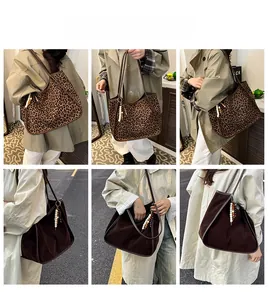 Detail view of large leopard print tote and brown suede shoulder bag with beaded charm
