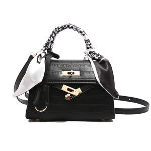 Classic black crocodile pattern handbag with gold twist lock and printed scarf wrap