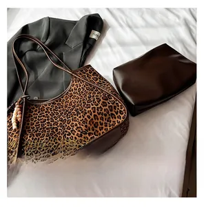 Leopard print tote bag set with brown leather handles and matching zipper pouch