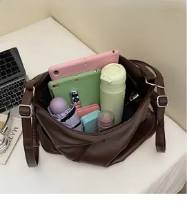 Detailed interior view of a large vintage brown leather tote showing ample storage capacity