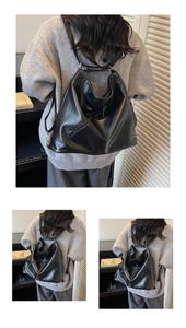 Close-up of matte black leather backpack with silver zipper and soft dumpling structure