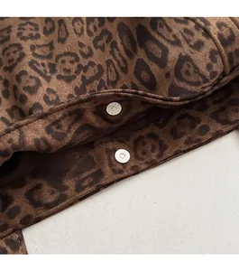 Detail of leopard print tote bag featuring magnetic snap closure and soft suede texture