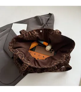 Detail view of large leopard print tote bag interior showing spacious storage capacity