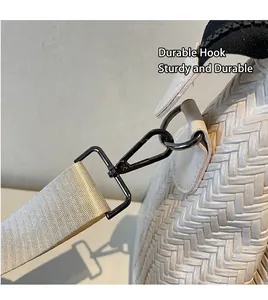 Detailed close-up of durable metal hook and woven texture on a white travel bag