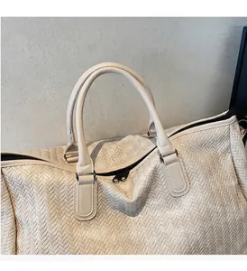 Detail of woven texture handbag with sturdy handles and high-quality zipper closure