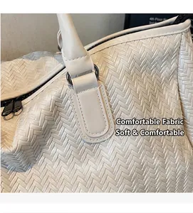 Close-up of cream woven fabric texture with black zipper detail on a travel bag