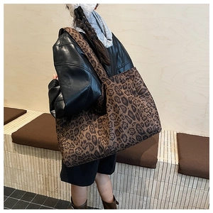Detailed back view of a large leopard print tote bag worn on shoulder for daily commute