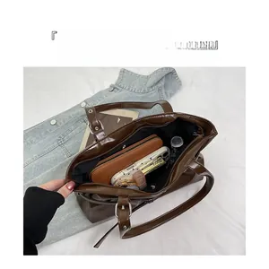 Deep brown tote bag showing a spacious interior layout with multiple compartments