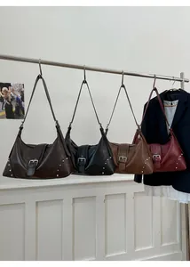 Detailed display of vintage crescent tote bags in four colors with metal buckle and rivets