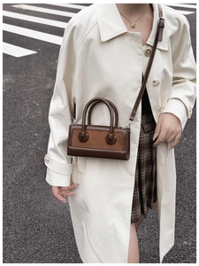 Detail of vintage brown rectangle handbag with PU leather and matte splicing texture