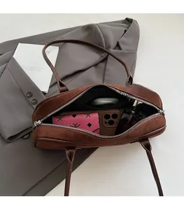 Top view of spacious brown suede baguette bag showing large capacity for essentials