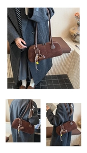 Close-up of dark brown suede pillow bag featuring heart pendant and woven tassel detail
