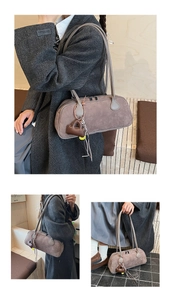 Close-up of vintage brown suede pillow bag with heart charm and shoulder strap detail